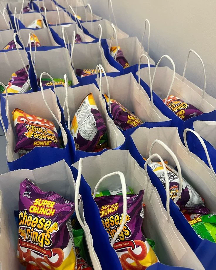 Blue and white snack bags arranged for a party