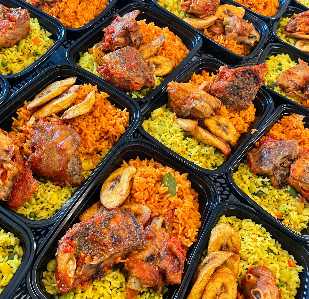 Individual event meal trays filled with rice, plantain and meat